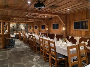 a dining room with a long table and chairs at Alver Hotel in Alversund