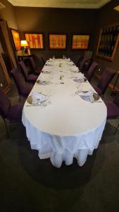 a large white table with wine glasses on it at Le Loft in Bamako