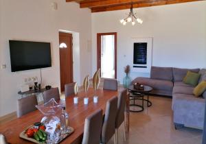 a living room with a table and a couch at VILLA HALEPOURI in Chania Town