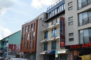 a building with a hotel sign on a city street at Hotel Alexander's in Nitra