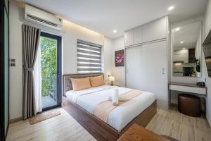 a bedroom with a large bed and a large window at Cozrum Homes - Kena House in Ho Chi Minh City
