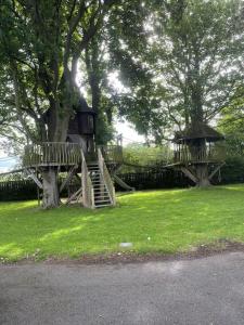 a tree house in the middle of a park at Castle Gogar Cottage in Edinburgh