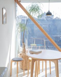 a table and two stools and a table with a laptop at FUN - Vacation STAY 48765v in Kanazawa