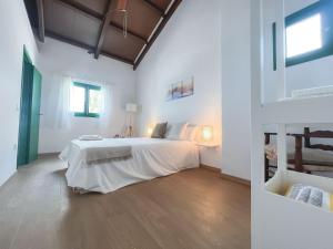 a white bedroom with a large white bed in it at MASIA BLANCA in Deltebre