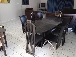 a black dining room table with black chairs at Heberden chalets in Melville