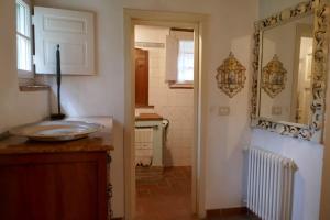 a kitchen with a sink and a mirror on the wall at Casa spaziosa in caratteristico paesino di alta collina in Santa Maria Albiano