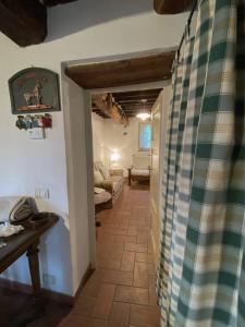 a hallway with a living room with a couch and a table at Casa spaziosa in caratteristico paesino di alta collina in Santa Maria Albiano