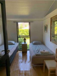 Postel nebo postele na pokoji v ubytování Sommerhus, Hornbæk