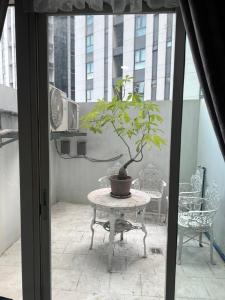 a potted plant sitting on a table on a patio at Eton Emerald Loft ortigas in Manila