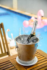 a bottle of champagne in an ice bucket next to a pool at Hotel Rotorua inn Fortaleza - Beira Mar in Fortaleza