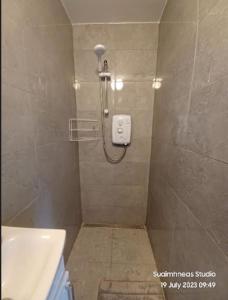 a bathroom with a shower and a sink at Teach Beag, Gortaforia, Kells, V23 N978 in Killarney
