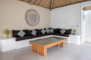 a living room with a couch and a table at Villa Dipta in Seminyak