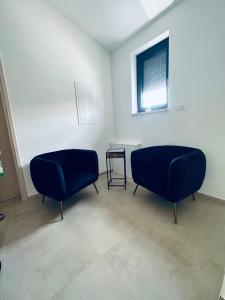 two blue chairs in a room with a window at Villa Istra Relax Diamond in Rebići