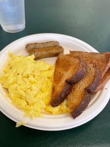 a plate of breakfast food with toast and scrambled eggs at Badlands Hotel & Campground in Interior
