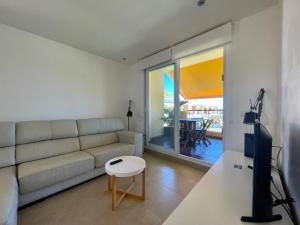 a living room with a couch and a table at Casas Del Mar in Oliva