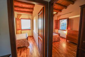 a bedroom with two beds and a dresser at Agriturismo Case Rapputi in Lascari