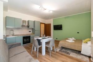 a living room with a couch and a table and a kitchen at Torino Comfy Apt in Turin +10 photos