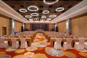 a large room with tables and chairs in it at Courtyard by Marriott Hangzhou Xiaoshan in Hangzhou