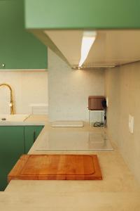 a kitchen with a wooden floor and a sink and a table at Malta Lake - Apartment in Poznań