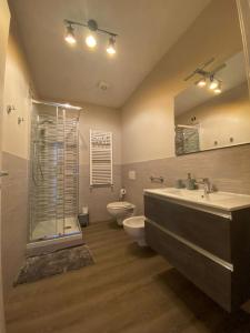 een badkamer met een douche, een wastafel en een toilet bij Casa Vacanze Spolina in Cossato