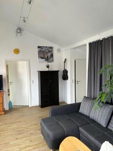 a living room with a couch and a tv at Bodden-Adler in Fuhlendorf