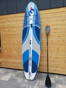 a blue and white surfboard sitting next to a spoon at Warchały Lake House in Warchały