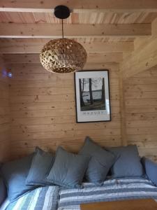 a bedroom with a bed in a wooden wall at Warchały Lake House in Warchały