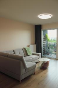 a living room with a couch and a table at Malta Lake - Apartment in Poznań