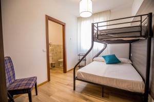 a bedroom with a bunk bed with a chair and a mirror at RESIDENCE VILLA TOTA in Spoleto