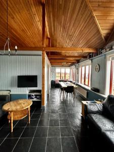 a living room with a couch and a table at Kría Cottages in Skeljabrekka