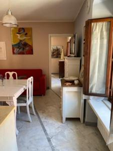 a living room with a red couch and a table at Casa in centro storico a Carrara in Carrara