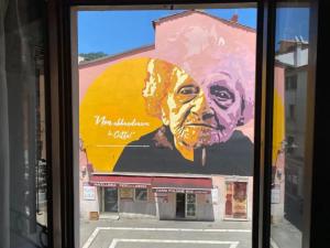 a large painting of a man on the side of a building at Casa in centro storico a Carrara in Carrara
