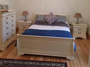 a bedroom with a bed with two night stands at The Old Dispensary in Kinsale