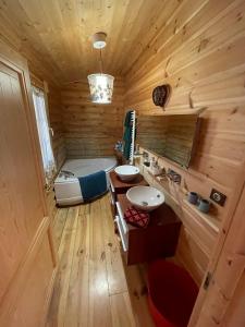 a bathroom with a tub and a sink in a room at Magnifique chalet avec SAUNA in Roubion