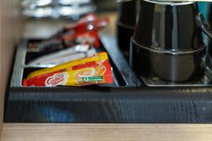 a black counter top with a drawer with a box of chips at Nala Veli Villa in Ukulhas