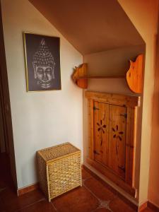 a room with a wooden cabinet and a picture on the wall at Villa EMMA in Málaga