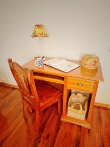 a wooden desk with a lamp and a chair at Villa EMMA in Málaga