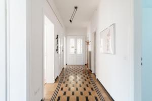un corridoio con pavimento a scacchi in bianco e nero di Giuka Apartment by Quokka 360 - close to the station a Massagno