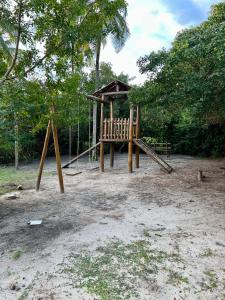 a playground with a slide and a swing set at apto vista mar imbassai in Imbassai