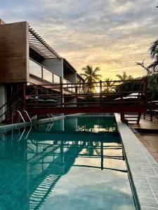 a swimming pool in front of a building at apto vista mar imbassai in Imbassai