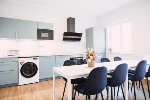 a kitchen with a white table and chairs at House of Blooms in Fulda