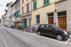 a car parked on the side of a street with bikes at Giardino della Fortezza & San Lorenzo Central Flat in Florence