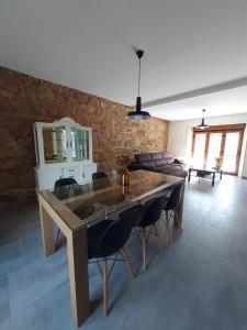 a living room with a large wooden table and chairs at Casa Rojo in Camariñas +9 photos