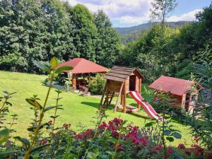 a garden with a playground and a slide at Agroturystyka Jelenia in Wisła