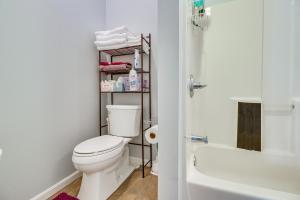 a bathroom with a white toilet and a bath tub at Kentucky Retreat Near Williamstown Lake! in Williamstown +17 photos