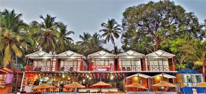 a resort with a building with trees in the background at Sai Valentines in Canacona