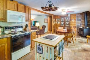 a kitchen with a stove and a dining room at Pet-Friendly Elkins Vacation Rental with Decks! in Elkins
