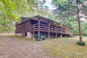 a large wooden house with a tractor in front of it at Pet-Friendly Elkins Vacation Rental with Decks! in Elkins