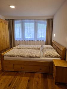 a large bed in a bedroom with a window at Apartment Huter in Jerzens
