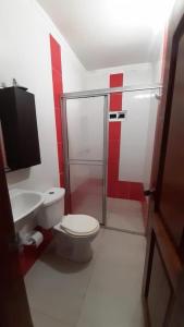 a bathroom with a shower and a toilet and a sink at HABITACIONES EN casa de playa in Coveñas